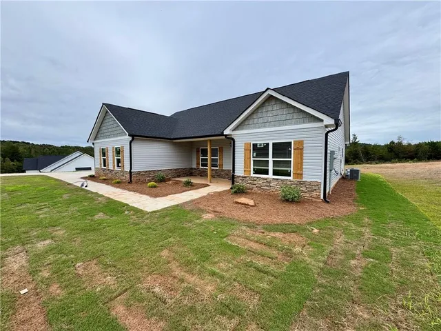 a front view of house with yard and green space