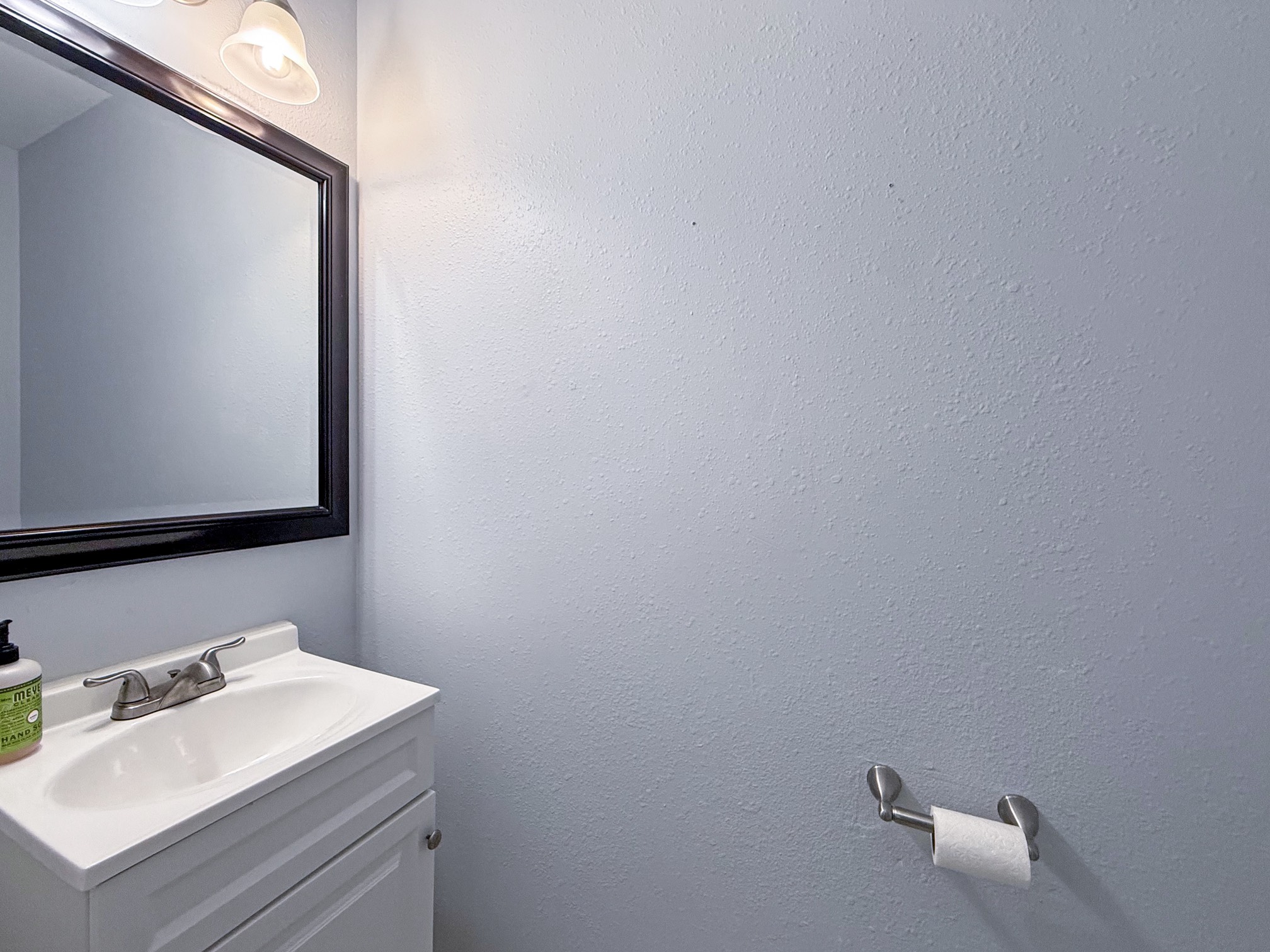 3 Peach Ridge Place The Woodlands, TX 77382 - Photo 9 of 22 a bathroom with a sink and a mirror