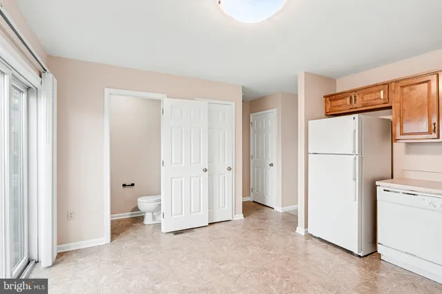 a view of a kitchen with refrigerator and cabinet