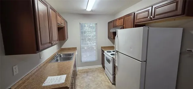 a kitchen with stainless steel appliances granite countertop a refrigerator and a stove