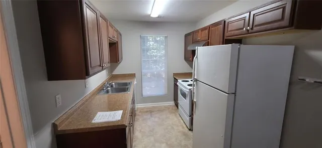 a refrigerator freezer sitting inside of a kitchen