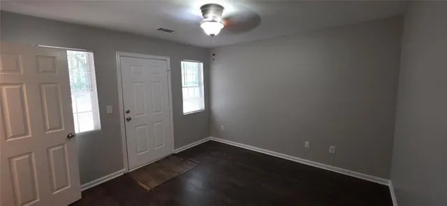wooden floor in an empty room with a window