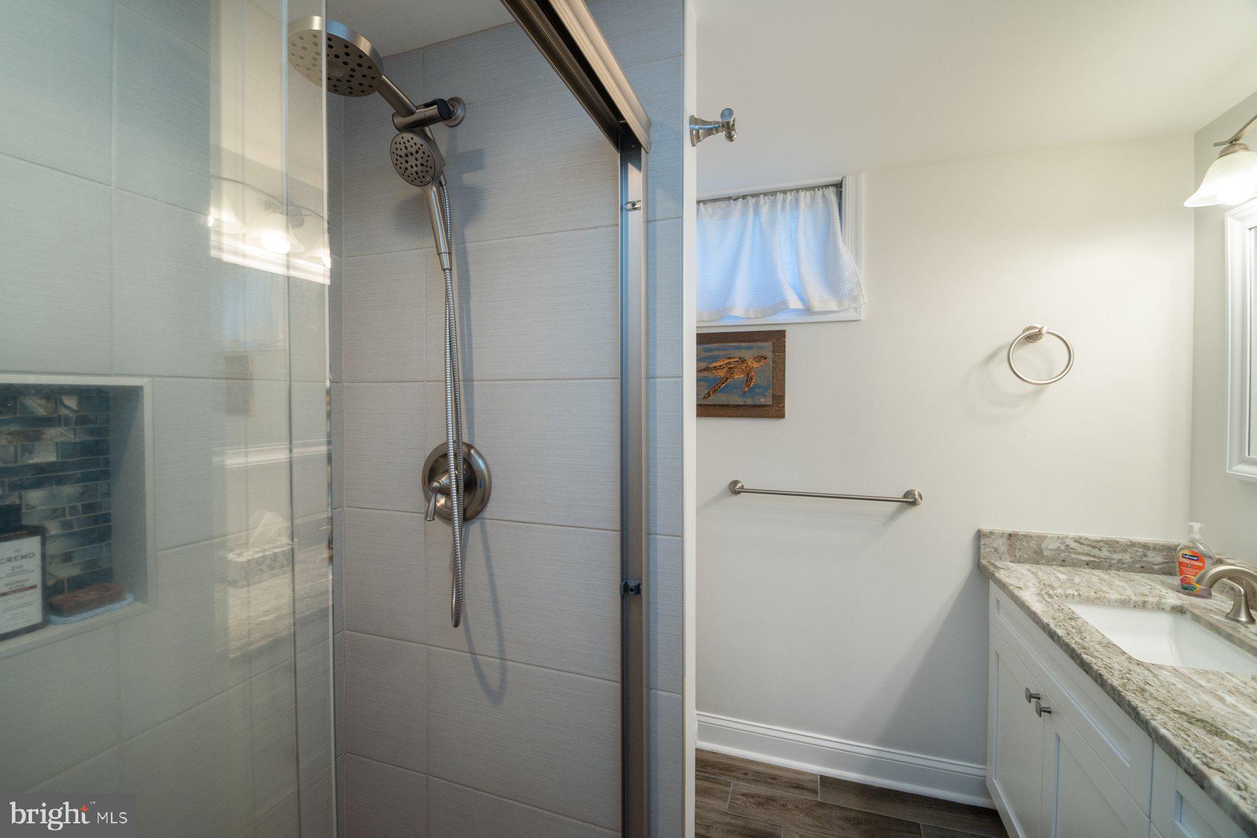206 Cheddington Road Linthicum Heights, MD 21090 - Photo 17 of 27 a bathroom with a shower and a sink