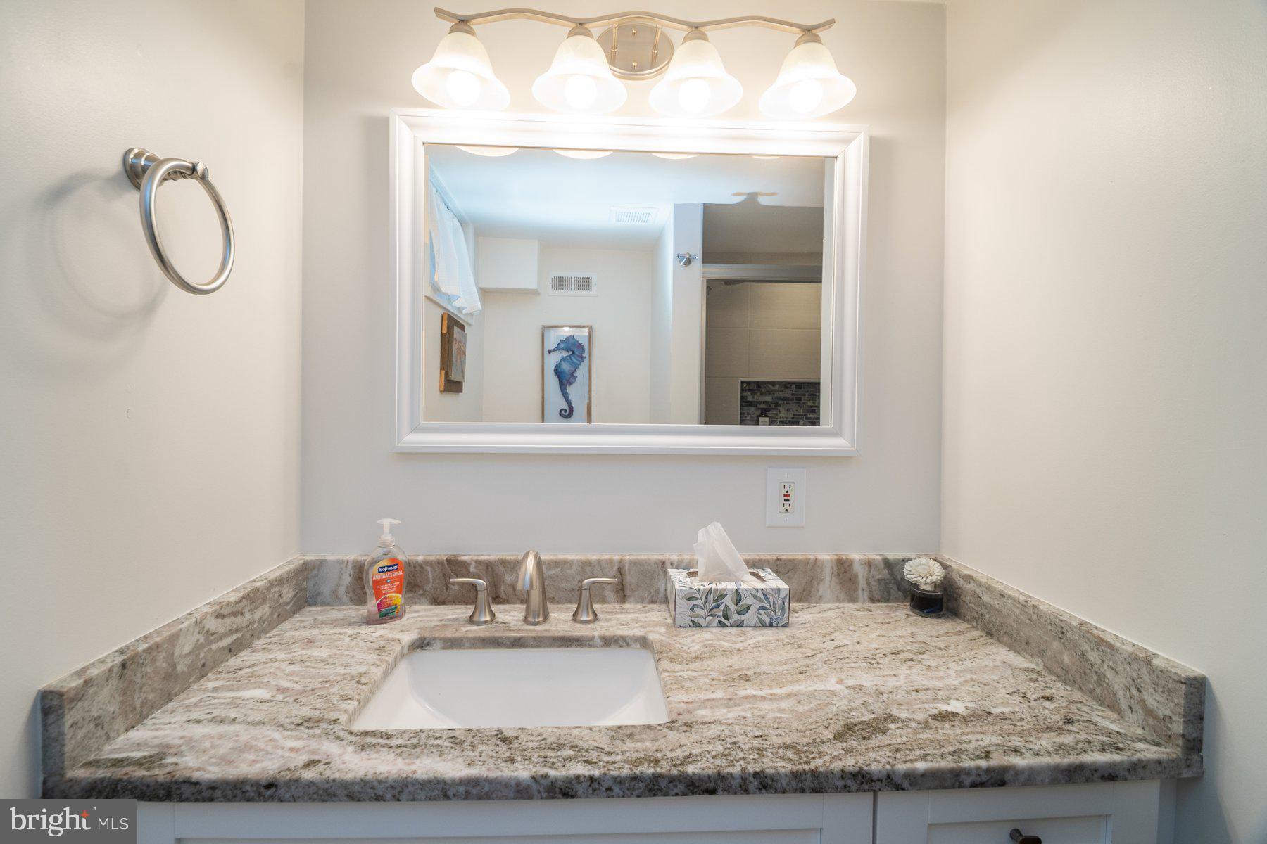 206 Cheddington Road Linthicum Heights, MD 21090 - Photo 18 of 27 a bathroom with a granite countertop sink and a mirror