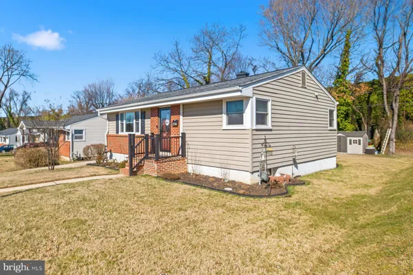 a view of a house with a wooden fence