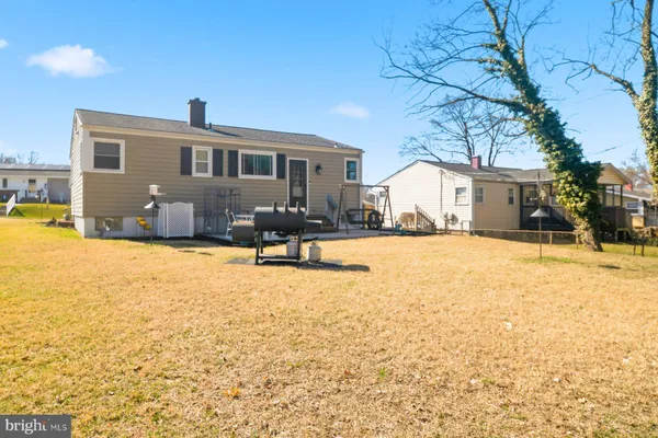 a front view of a house with a yard covered with snow