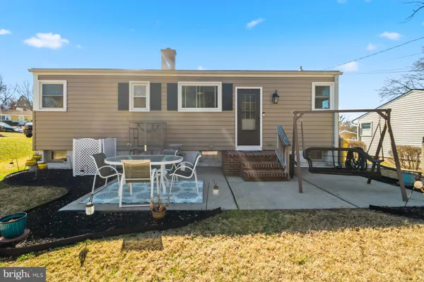 a view of a house with backyard and sitting area
