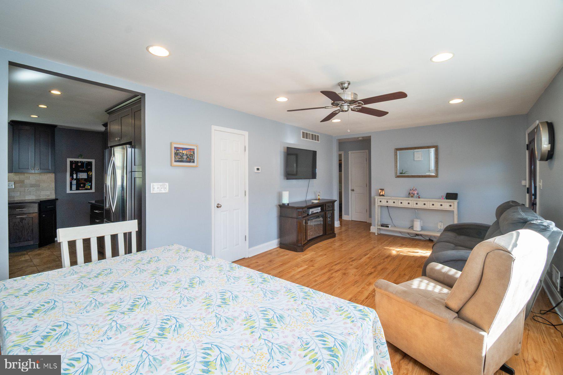 206 Cheddington Road Linthicum Heights, MD 21090 - Photo 5 of 27 a living room with furniture kitchen view and a flat screen tv