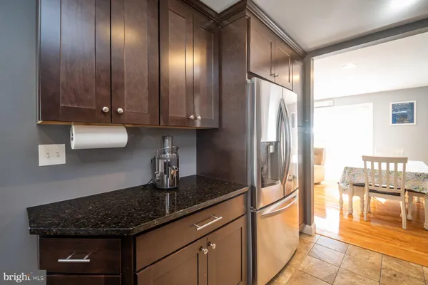 a kitchen with granite countertop stainless steel appliances and wooden cabinets