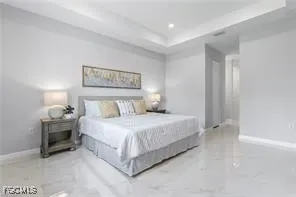 a bedroom with a bed and a night stand