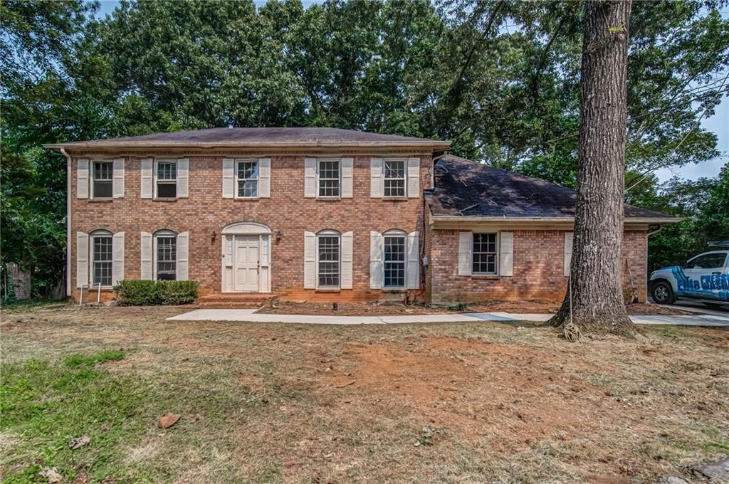a front view of a house with garden