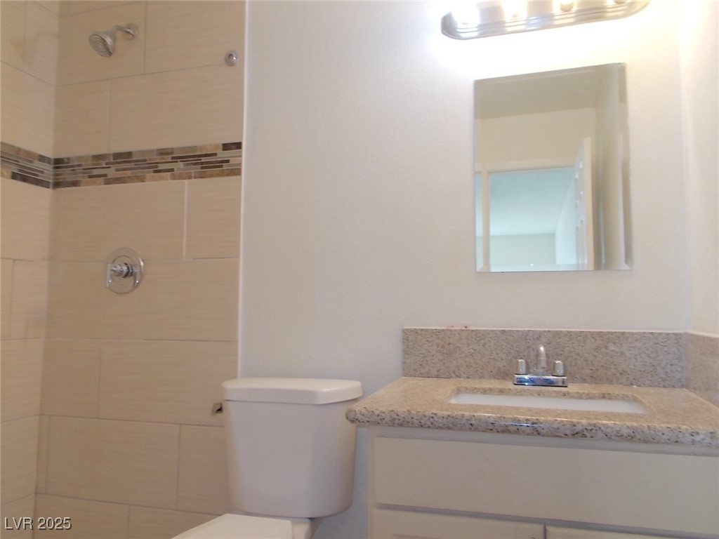 4521 Halbert Avenue Las Vegas, NV 89110 - Photo 14 of 16 Full bathroom featuring vanity, a tile shower, and