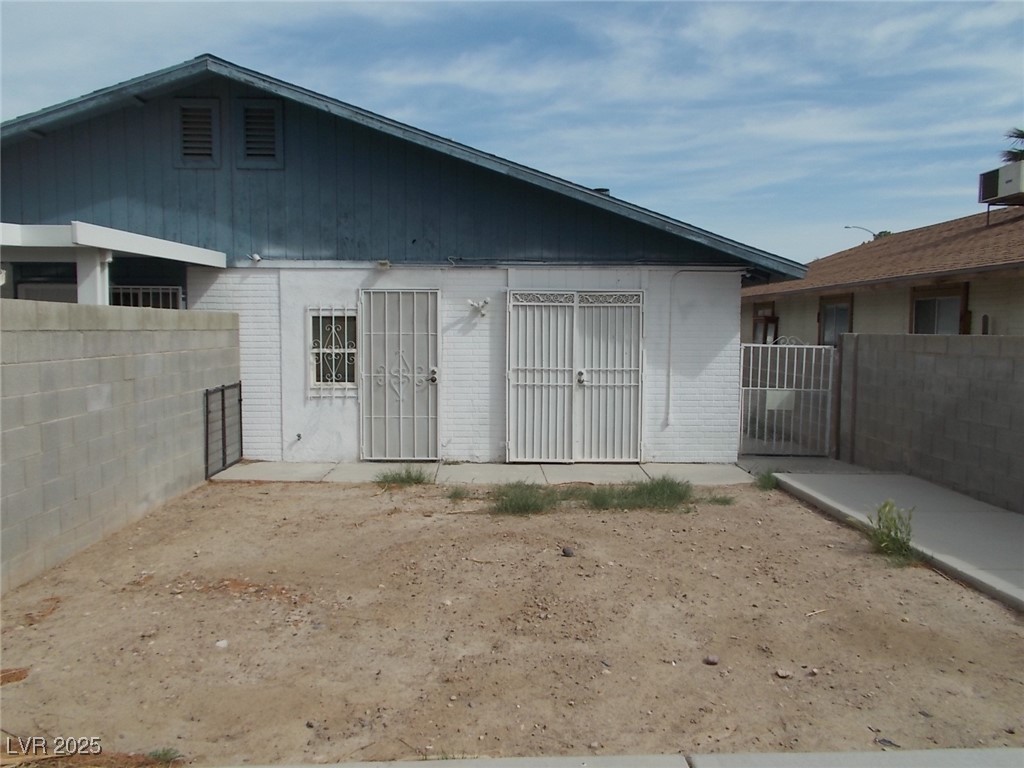 4521 Halbert Avenue Las Vegas, NV 89110 - Photo 15 of 16 Back of house featuring fence and brick siding