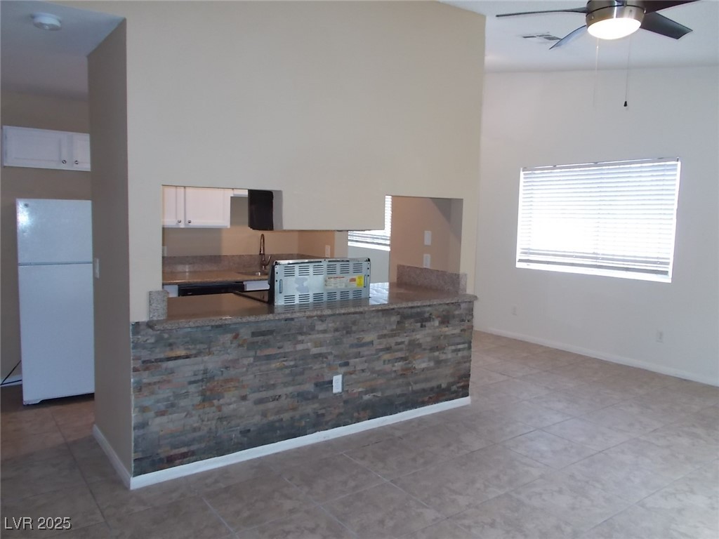 4521 Halbert Avenue Las Vegas, NV 89110 - Photo 5 of 16 Kitchen featuring a high ceiling, freestanding ref
