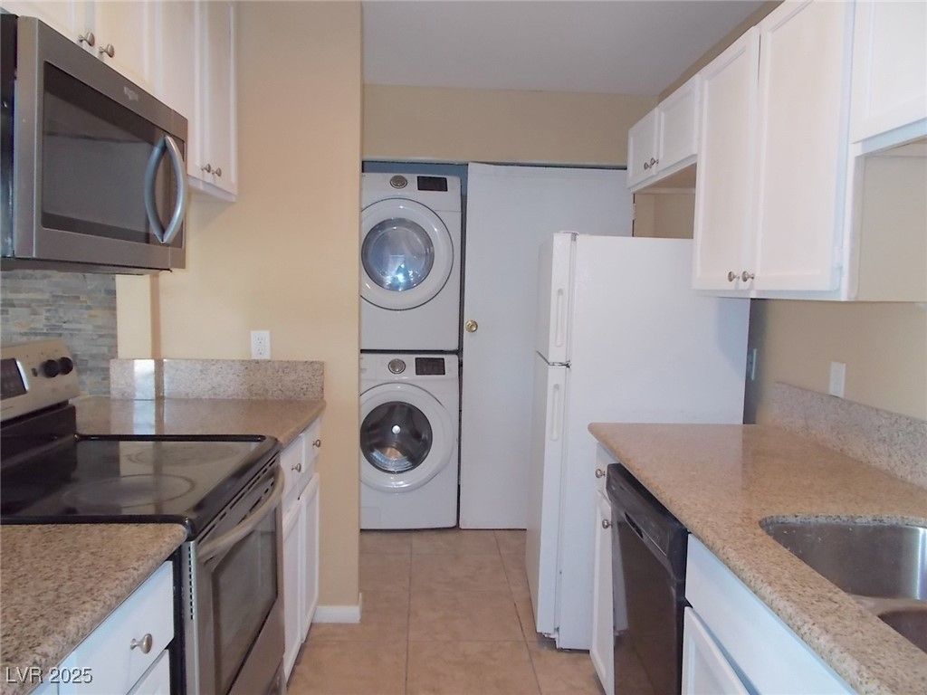 4521 Halbert Avenue Las Vegas, NV 89110 - Photo 7 of 16 Kitchen featuring white cabinetry, light tile patt