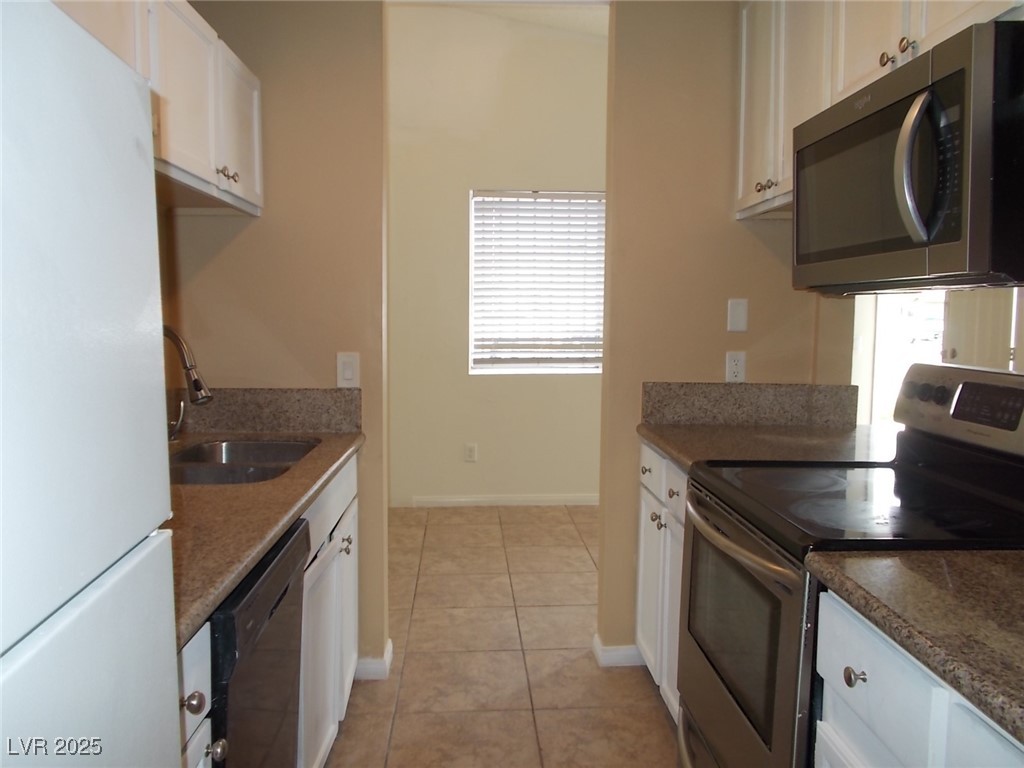4521 Halbert Avenue Las Vegas, NV 89110 - Photo 8 of 16 Kitchen featuring white cabinets, a sink, a wealth
