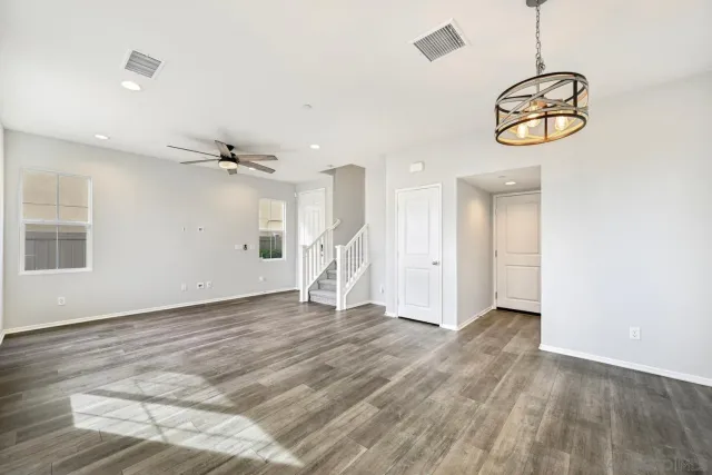 a view of a room with wooden floor and white walls