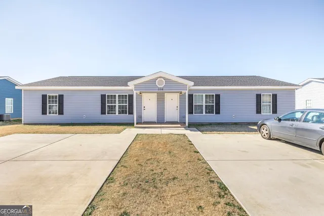 a front view of a house with yard