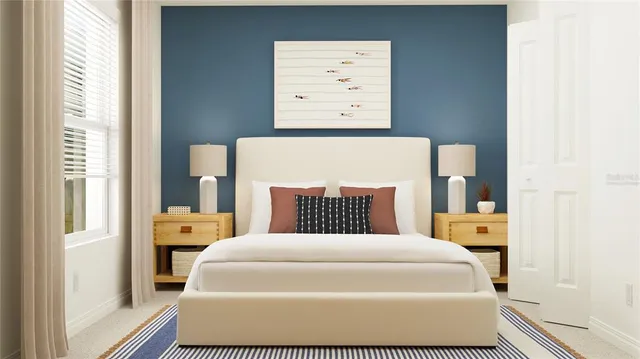 a bed sitting in a bedroom next to a window with a hallway