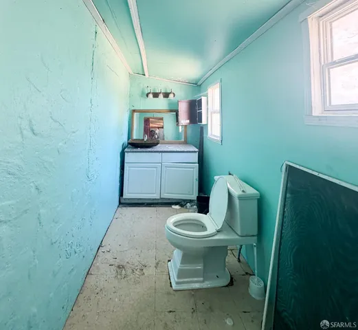 a white toilet sitting next to a white sink