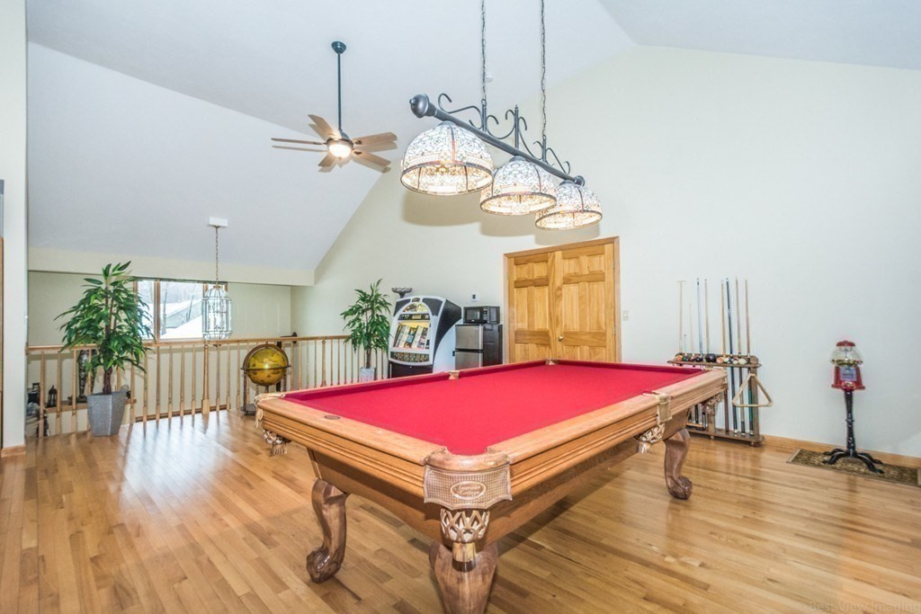 a room with pool table and windows
