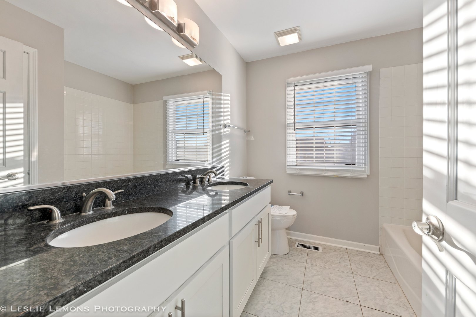 1219 Howe Street Batavia, IL 60510 - Photo 18 of 33 a bathroom with a granite countertop sink and a mirror