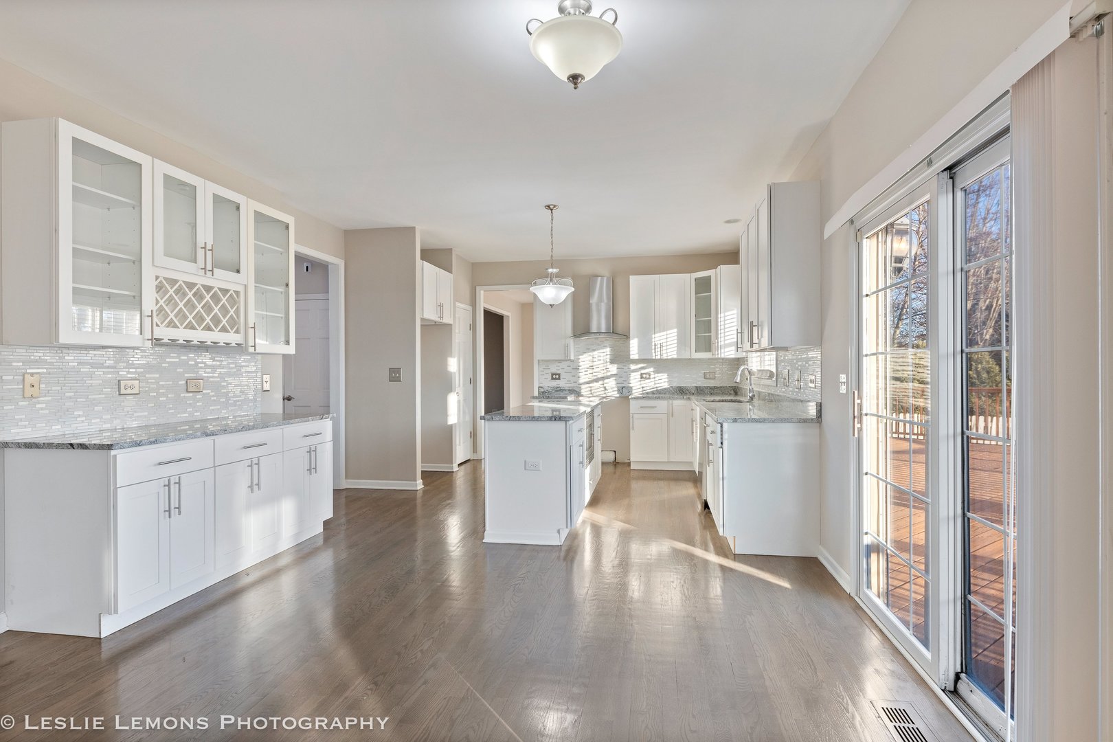 1219 Howe Street Batavia, IL 60510 - Photo 6 of 33 a large kitchen with white cabinets and stainless steel appliances