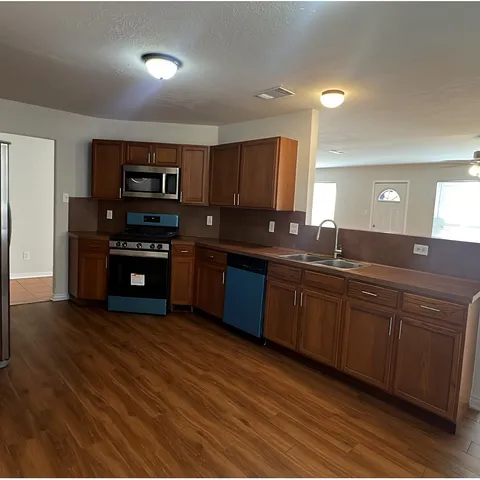 a kitchen with stainless steel appliances granite countertop a sink and cabinets