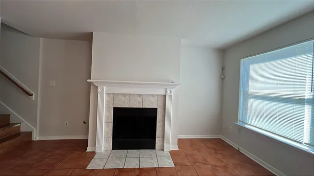 a living room with a rug and a fireplace
