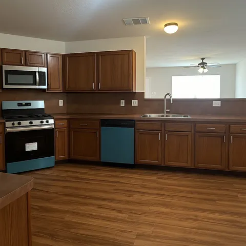 a kitchen with stainless steel appliances granite countertop a sink and stove top oven