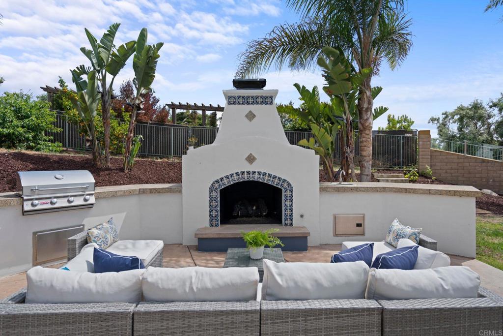 707 Olympus Street Encinitas, CA 92024 - Photo 24 of 47 a view of a patio with couches and a fireplace