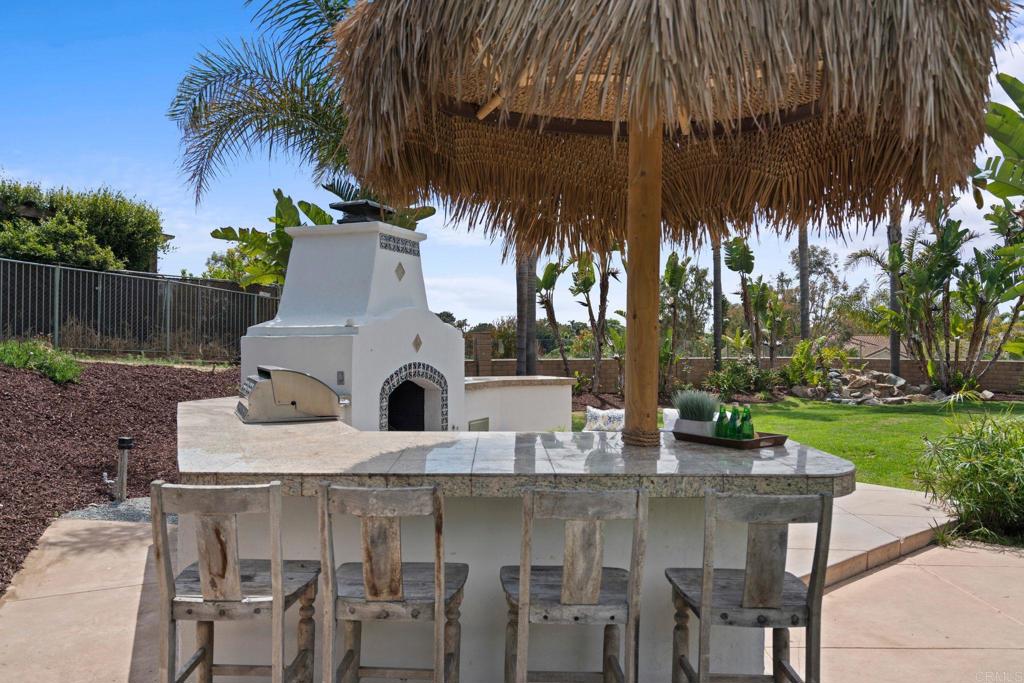 707 Olympus Street Encinitas, CA 92024 - Photo 25 of 47 a view of outdoor dining space with a table and chairs