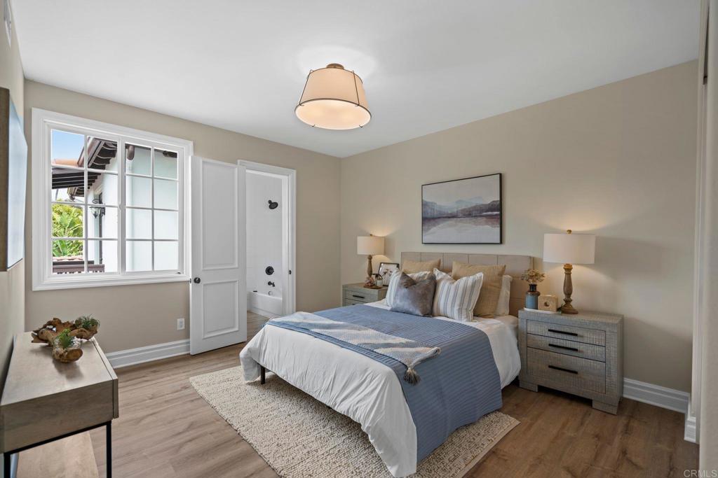 707 Olympus Street Encinitas, CA 92024 - Photo 37 of 47 a bedroom with a bed and wooden floor