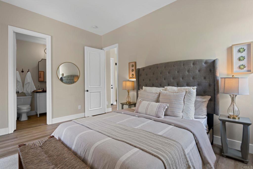 707 Olympus Street Encinitas, CA 92024 - Photo 47 of 47 a bedroom with a bed and a mirror
