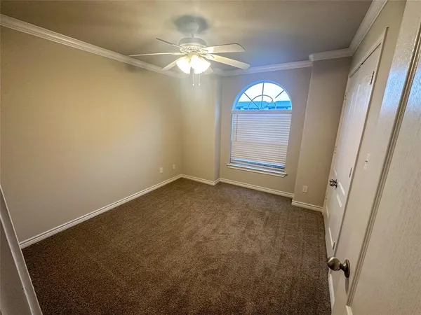 en empty room with a window and a fan