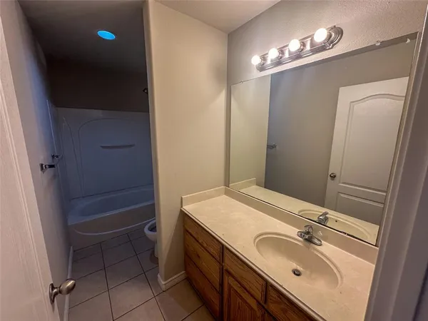 an empty room with a ceiling fan and a window