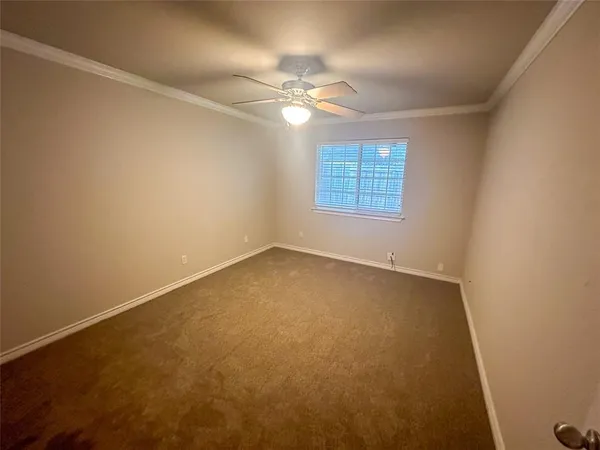 a spacious bathroom with a double vanity sink a toilet and a mirror