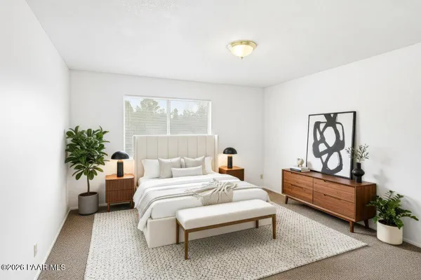a bedroom with a bed and a potted plant