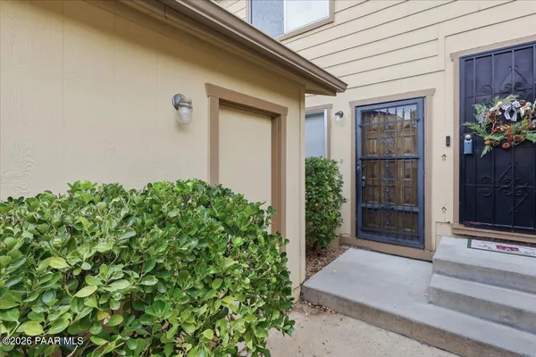 a couple of potted plants in front of door