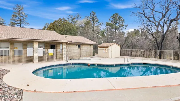 a view of a house with swimming pool and sitting area