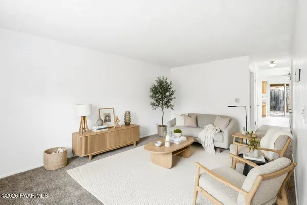 a living room with furniture and a potted plant