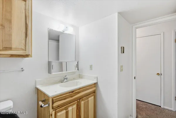 a bathroom with a sink a vanity and a mirror