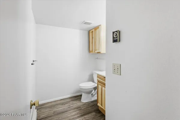 a bathroom with a toilet and a mirror