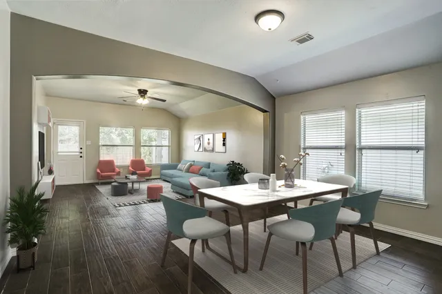 a view of a dining room with furniture and wooden floor