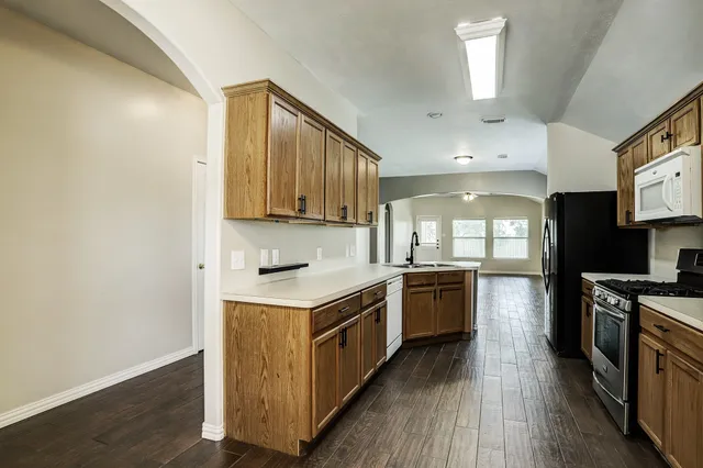 a kitchen with a stove top oven sink and cabinets