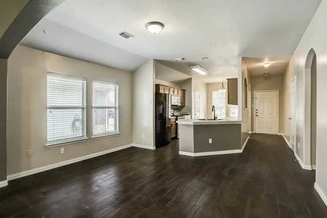 a view of a kitchen cabinets and wooden floor