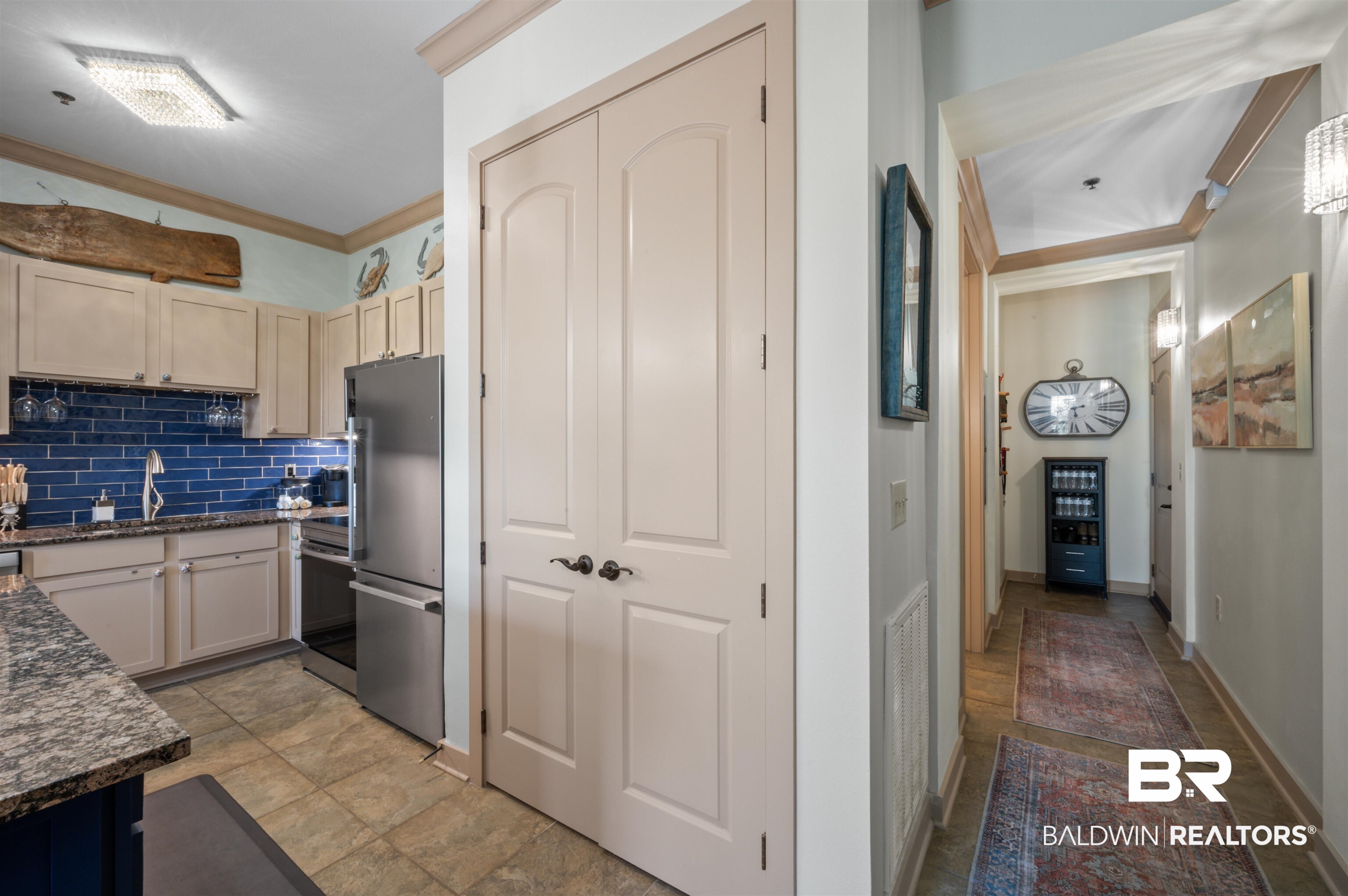 1430 Regency Road, Unit B202 Gulf Shores, AL 36542 - Photo 6 of 33 Kitchen with tasteful backsplash, electric range oven, ornamental molding, freestanding refrigerator, and a sink