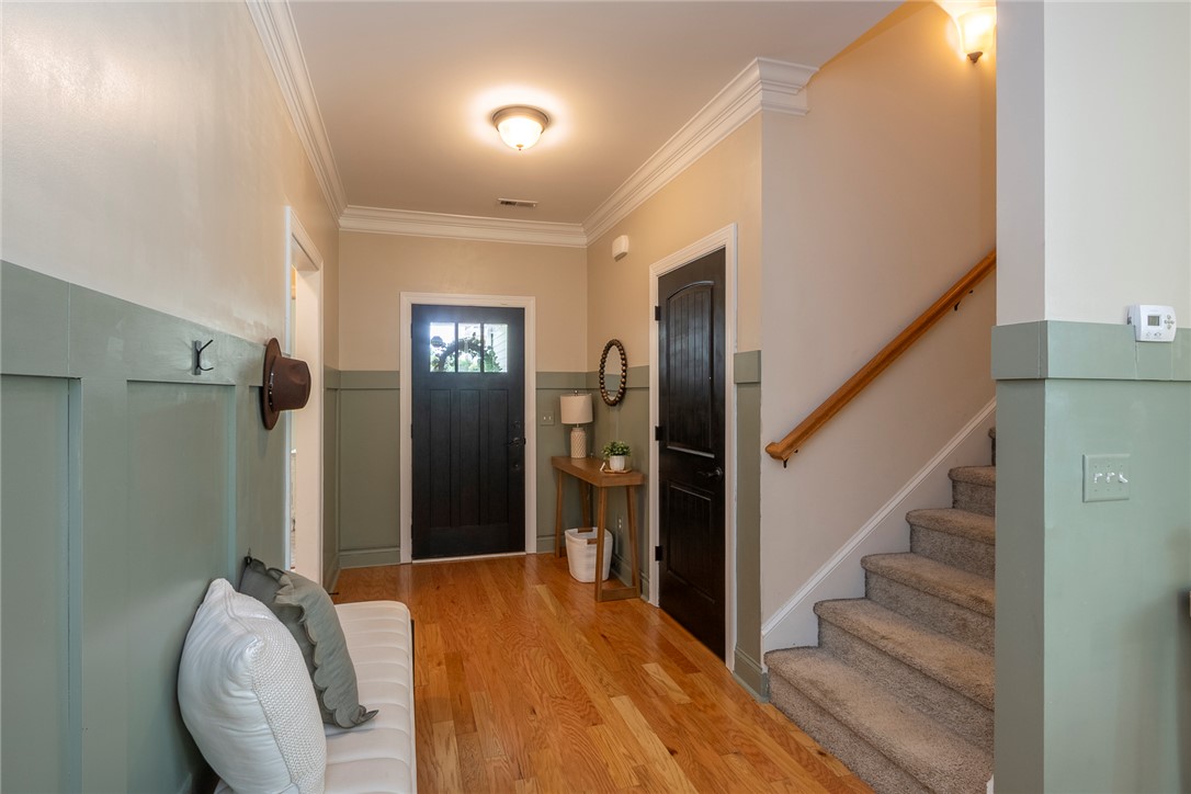234 Streams Way Anderson, SC 29625 - Photo 5 of 44 This inviting entry features warm hardwood floors and a staircase leading to additional living spaces.