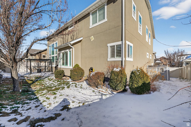14714 South Bright Wood Road Herriman, UT 84096 - Photo 38 of 41 Snow covered back and side yard with stucco siding