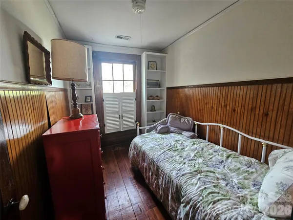 a bed sitting in a bedroom next to a window